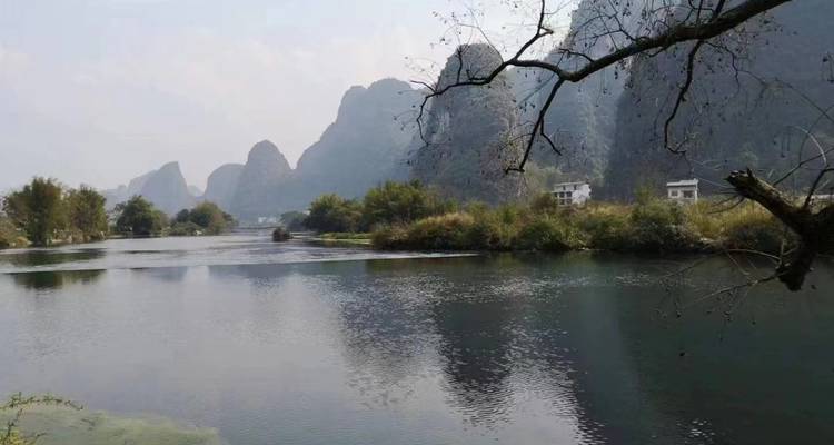 Peaceful river scene with mountains in the distance.