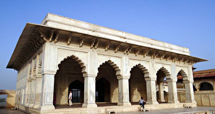 White marble structure with decorative archways.