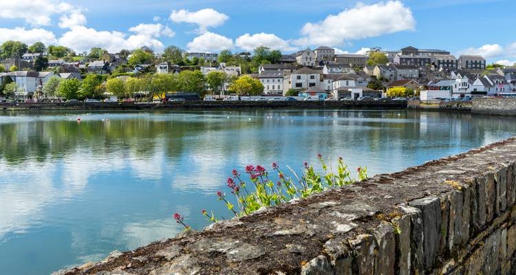 Scenic view of a coastal town reflected in calm water.