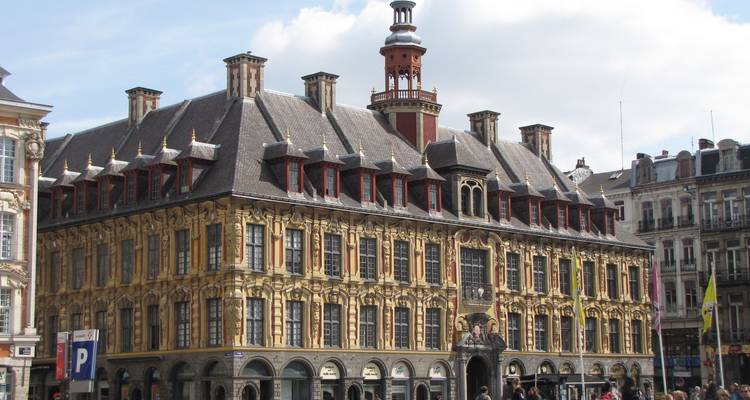 Historic building with classic architecture in a lively city square.