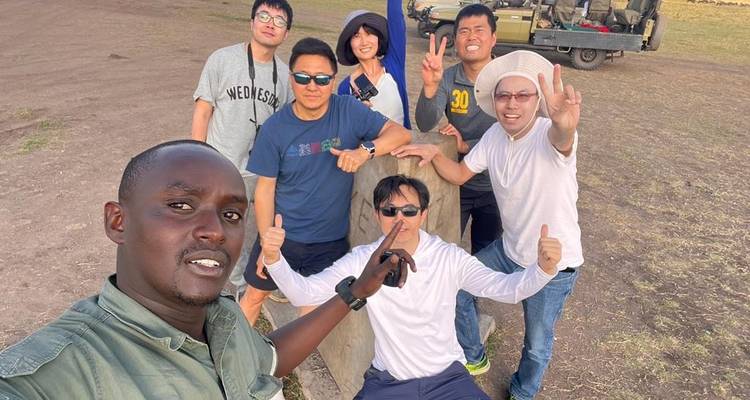 Groupe de personnes posant joyeusement dans un cadre de safari.