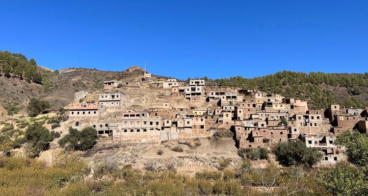 Blick auf ein verlassenes Bergdorf mit klarem blauen Himmel.