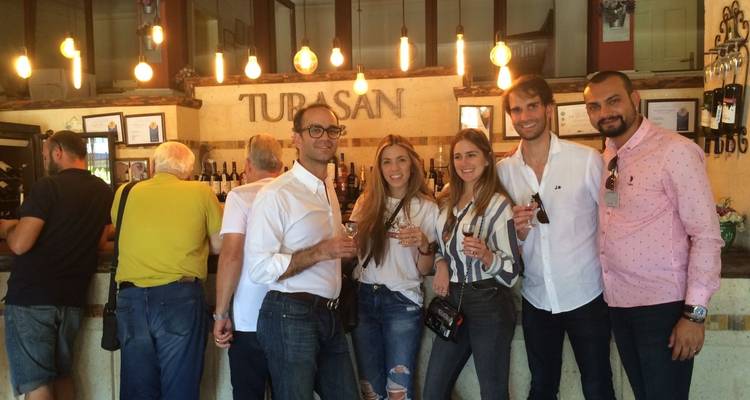 Group at a wine tasting with a bar in the background