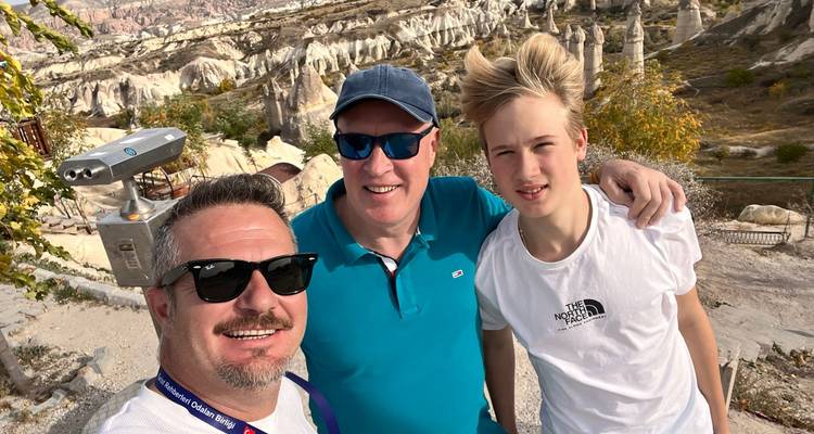 Family taking a selfie with Cappadocia's fairy chimneys.
