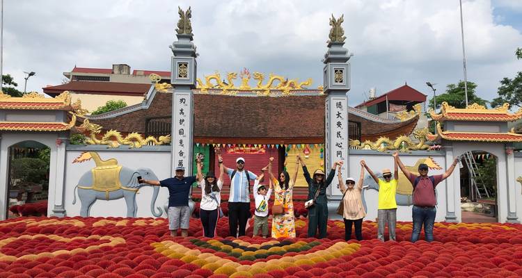 Groupe de touristes devant l'entrée d'un temple décoré.