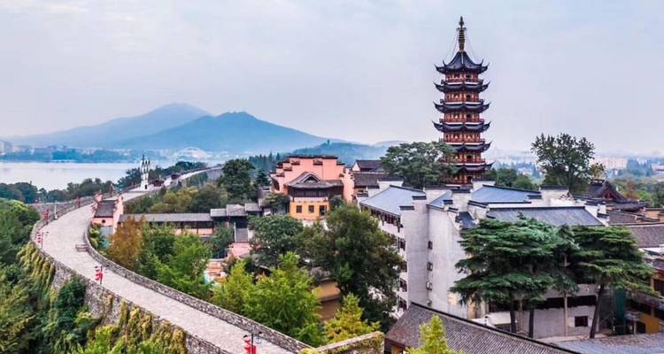 Pagoda in a scenic area with mountains in the background.