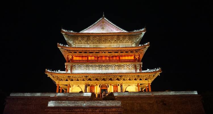 A traditional Chinese building illuminated at night.