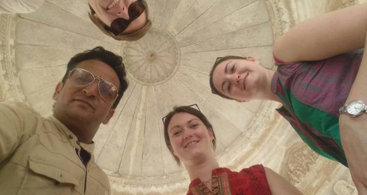Group selfie in a historical setting with a domed ceiling.