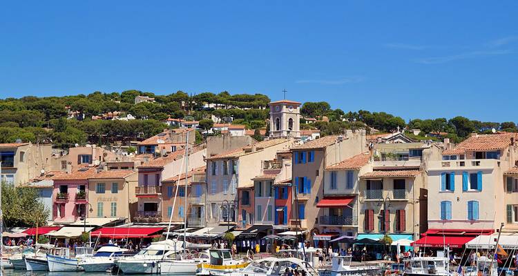 View of the harbor in Cassis with colorful buildings and boats.