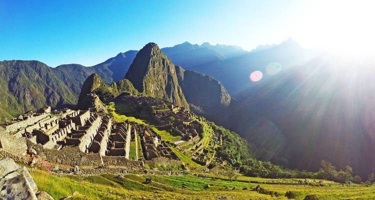 Majestic view of Machu Picchu surrounded by mountains at sunrise.