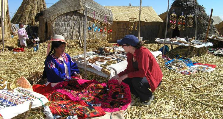Local market on Uros Floating Islands with people in traditional attire.