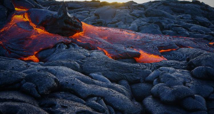 Flowing lava with glowing red and black rocks