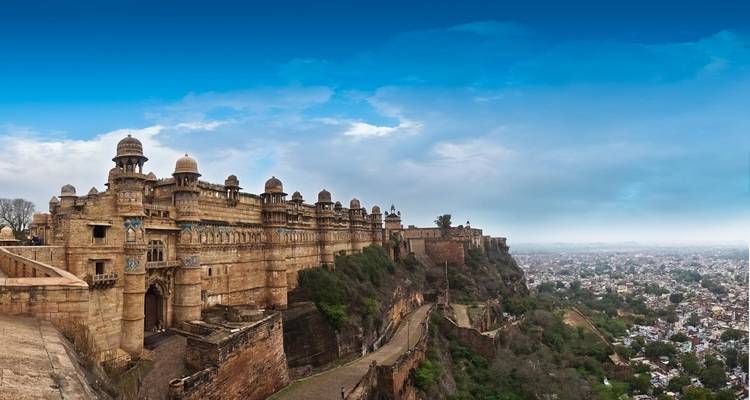 Panoramic view of a fort on a cliff with a city below.