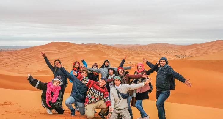 Group of people celebrating in a desert.