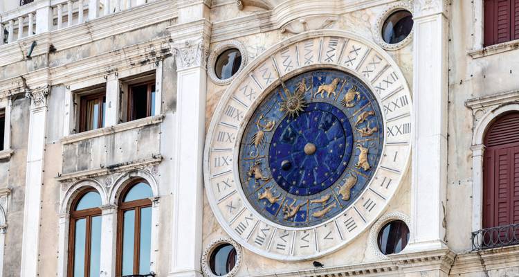 Detailed view of the ornate blue and gold astronomical clock on Venice’s St. Mark’s Clocktower.