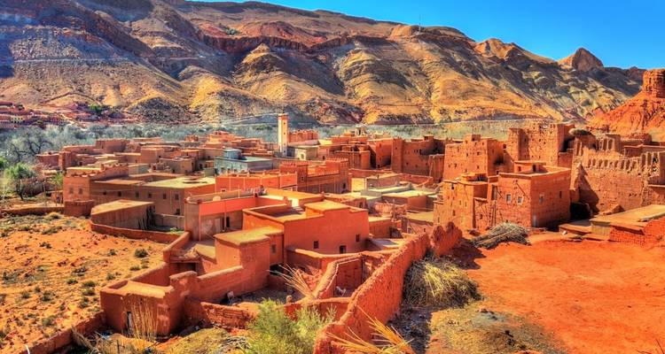 Landscape view of clay buildings and desert terrain.