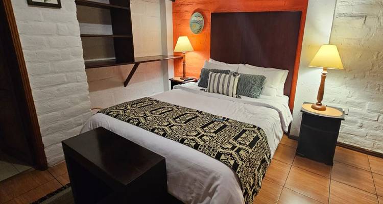 Cozy bedroom with modern decor and soft lighting.