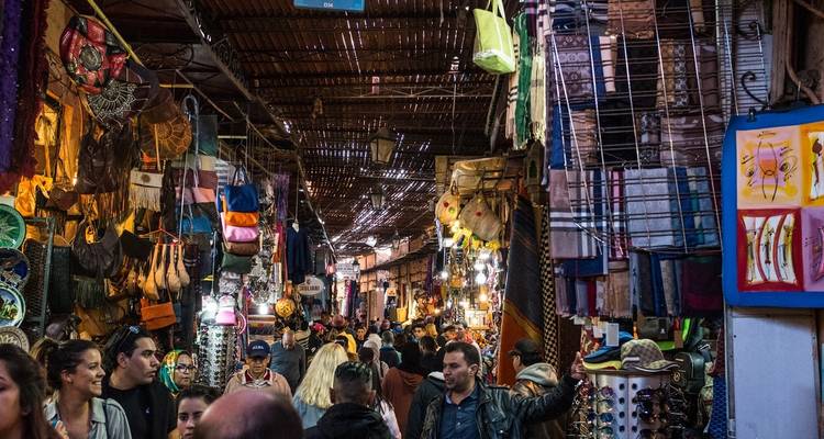 A bustling souk with various goods and people in Marrakesh.