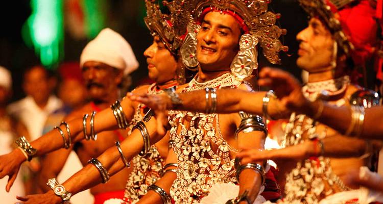 Traditional dancers in colorful costumes performing a cultural dance.