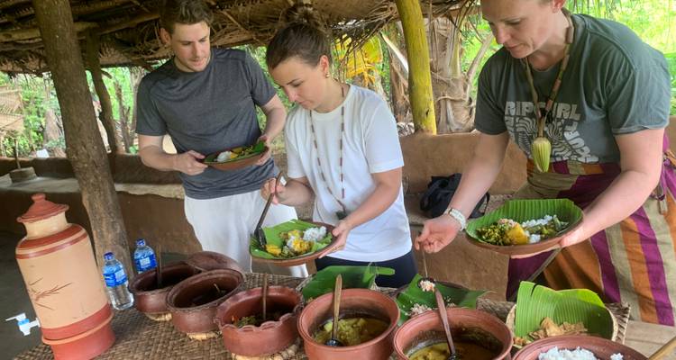 A group enjoying a meal with traditional dishes laid out on a table.