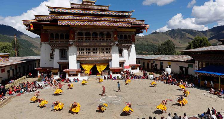 Cultural dance performance in front of a decorated building.