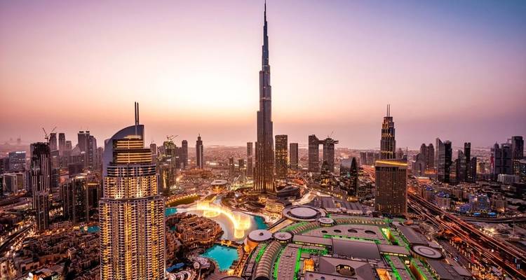 Overview of Dubai city with the Burj Khalifa at dusk.