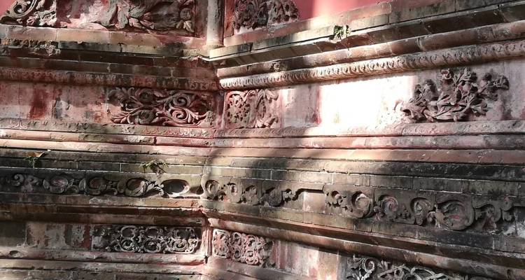 Close-up of ornate carvings on a temple wall.