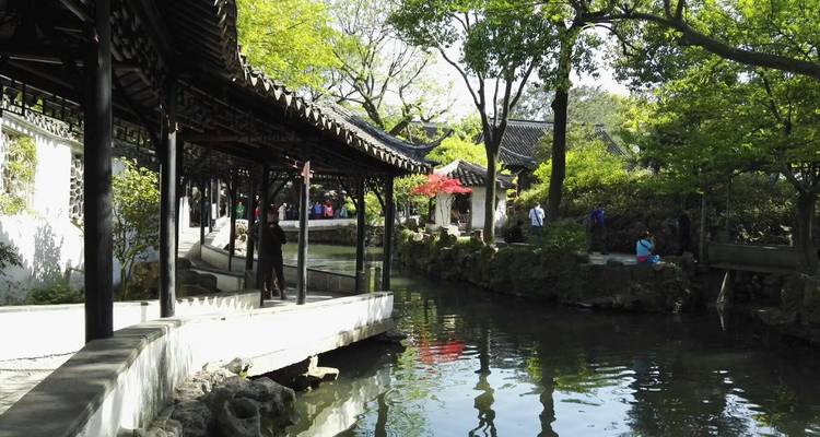 Scenic garden with a traditional Chinese pavilion by the water.