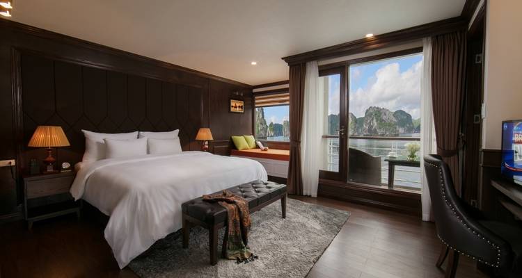 Spacious bedroom on a cruise with scenic views from the windows.