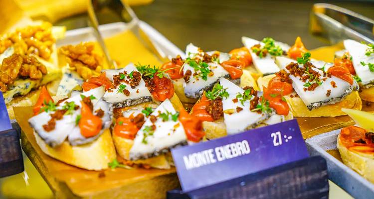 Assorted tapas on display with vibrant garnishing.