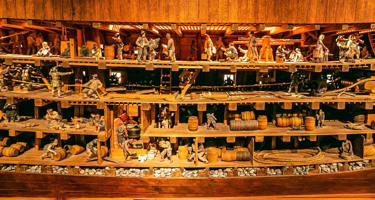 Model ship inside a wooden museum display.