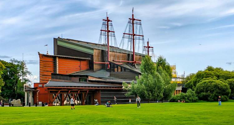 Unusual building with ship-like features in a park setting.