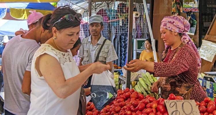 Crowd in a market with local produce.