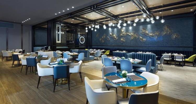 Hotel dining area with modern furniture and lighting.