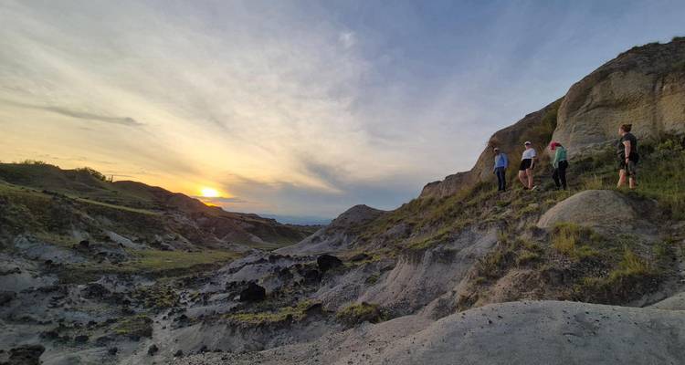 Small group hikes through dramatic grey rock formations of the Tatacoa Desert at sunset.