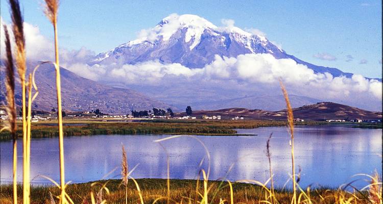 Snow-capped mountain reflected in a tranquil lake.