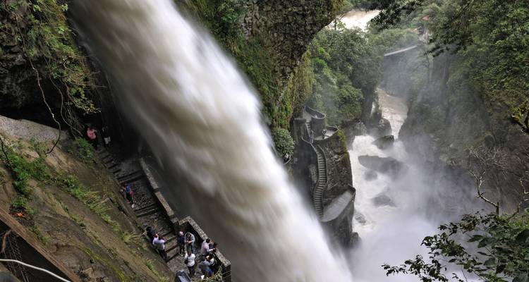 Dramatic waterfall view from a high vantage point with people.