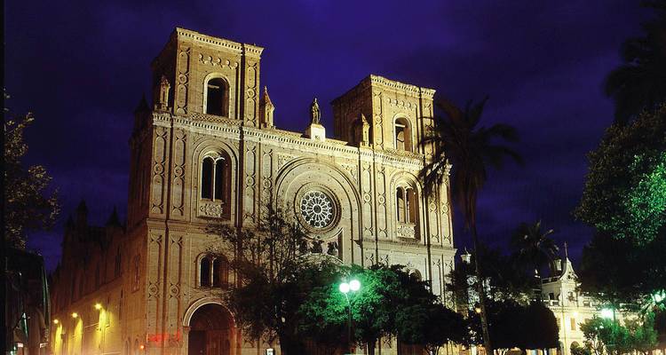 Illuminated cathedral against a deep blue night sky.