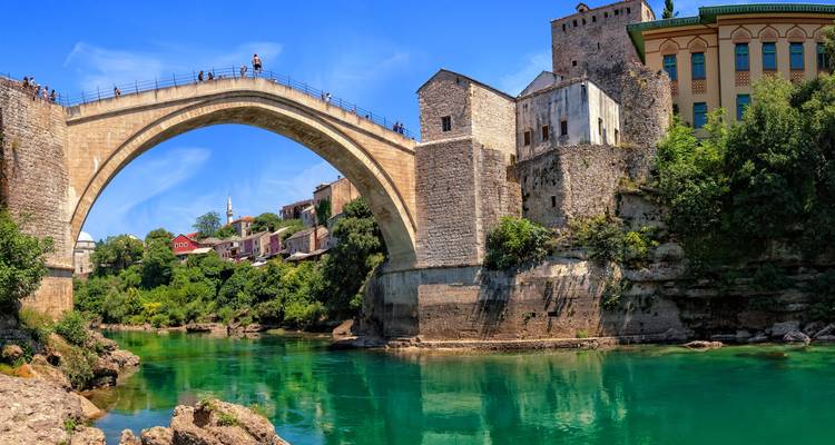 Iconic arched bridge over a river.