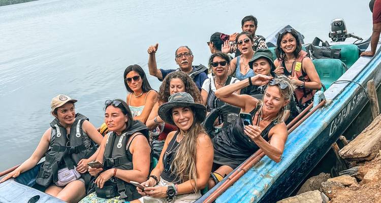 Group of tourists in a boat ready to enter a waterway.