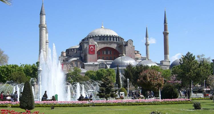 Hagia Sophia framed by fountains and landscaped gardens on a bright spring day in Istanbul.