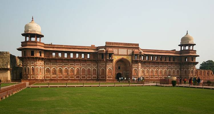Historical fort with a large green lawn in front.