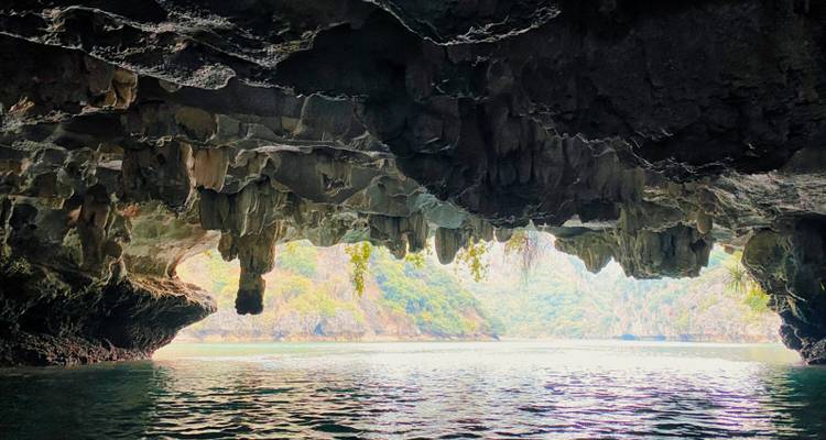 View from inside a cave looking out to the sea and cliffs.