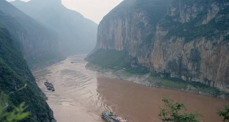 Aerial view of a winding river through steep cliffs.