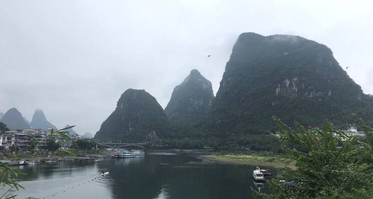 Karst mountains with a river winding through them, cloudy day.