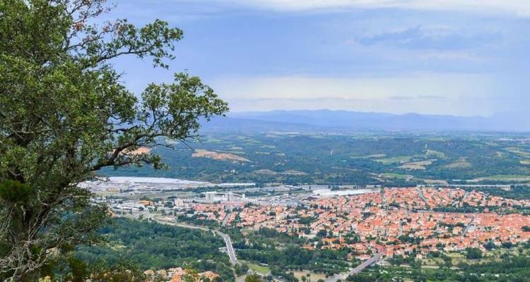Panoramic view over a town with a distant mountain range.