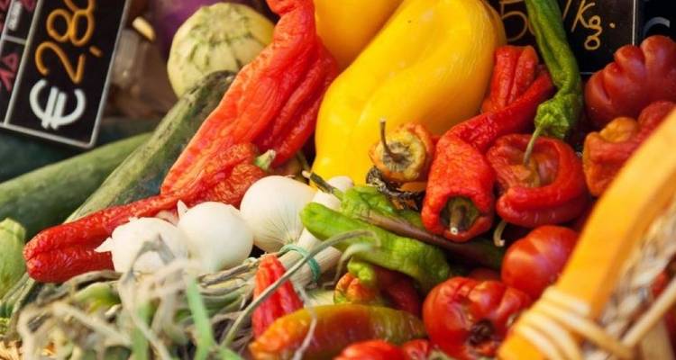 Assortment of colorful vegetables at a market stand.