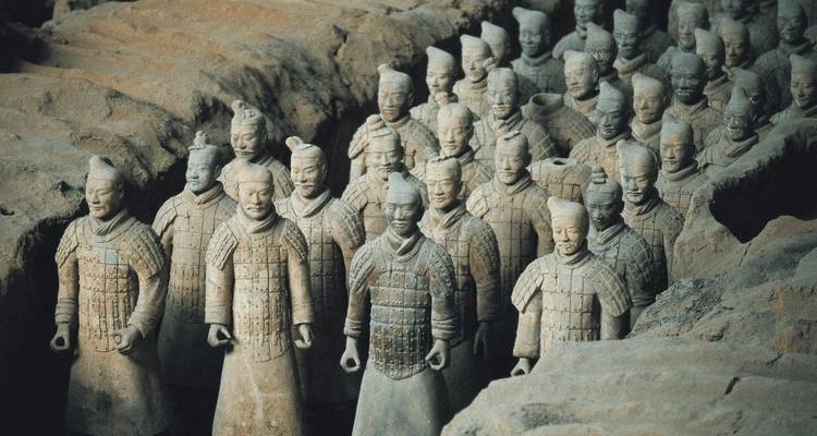 Terracotta army figures in protective armor standing in formation.