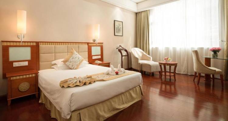 Hotel room with a bed and an armchair