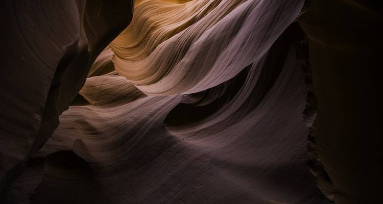 Walls of narrow canyon with textured rock patterns.